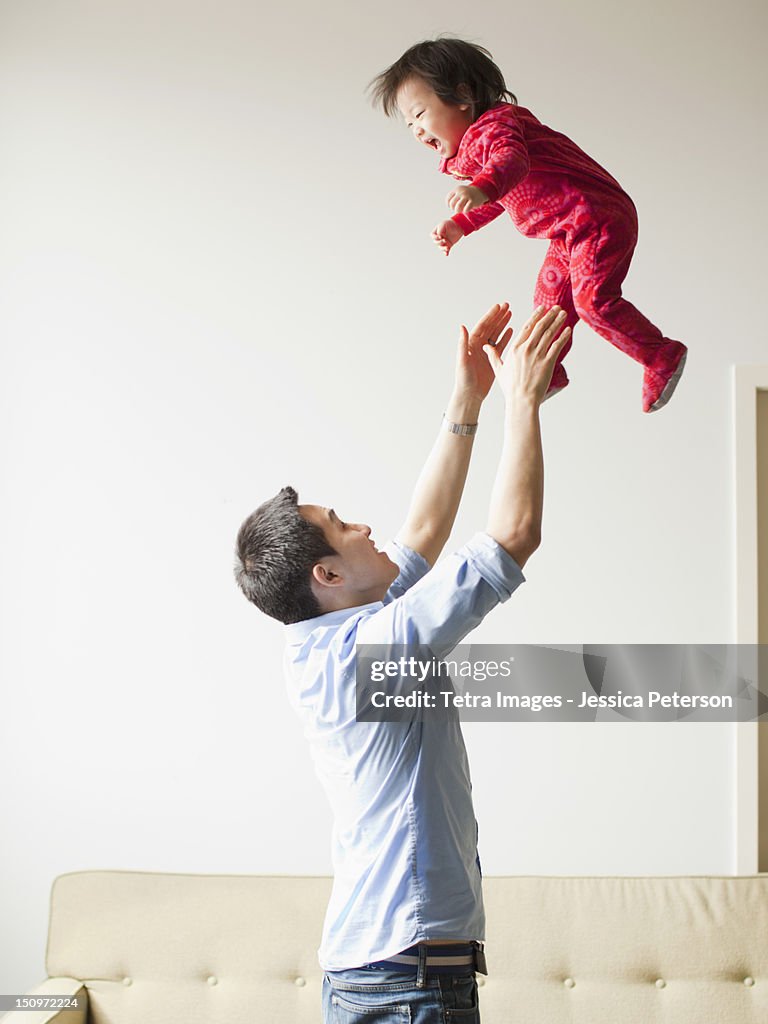 USA, Utah, Salt Lake City, Father playing with baby girl (12-17 months)