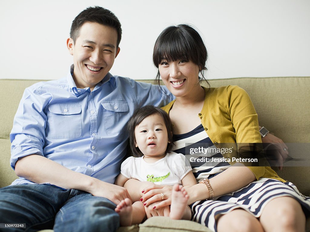 USA, Utah, Salt Lake City, Portrait of young parents with baby girl (12-17 months)