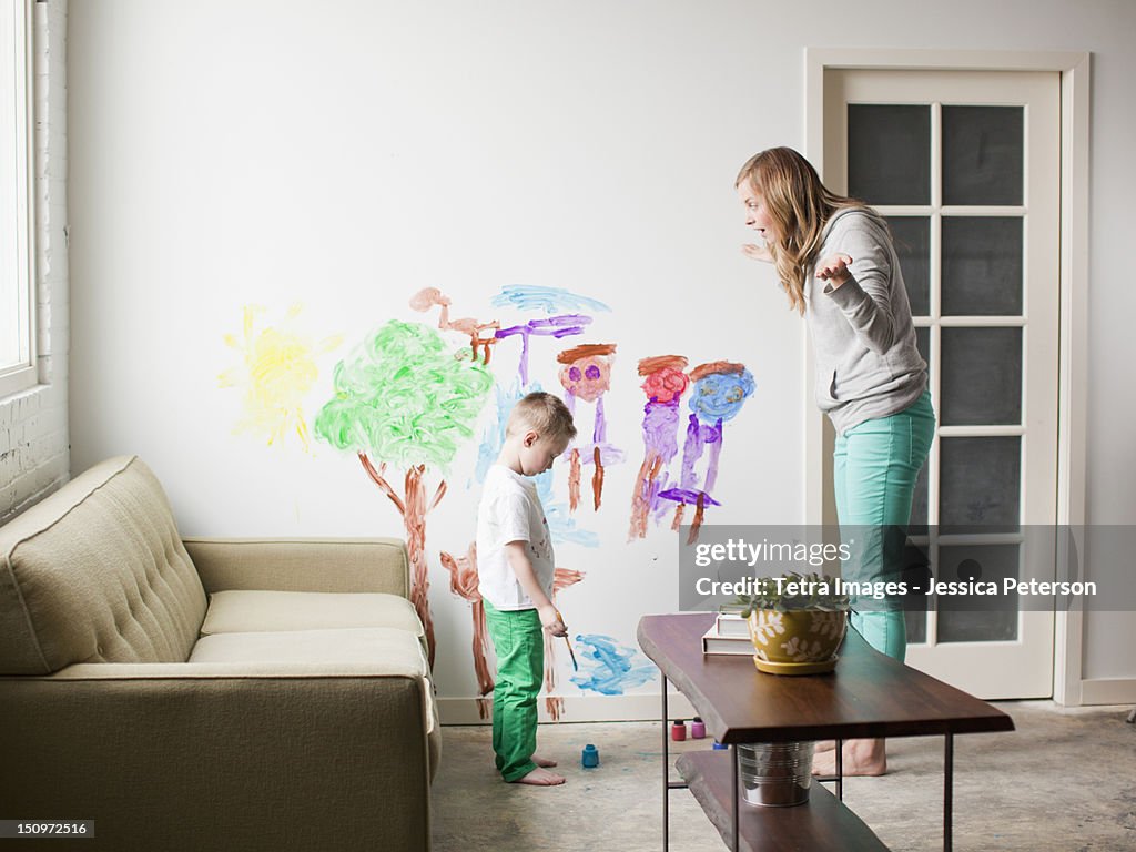 USA, Utah, Salt Lake City, Mother telling toddler boy (2-3) off for painting on walls