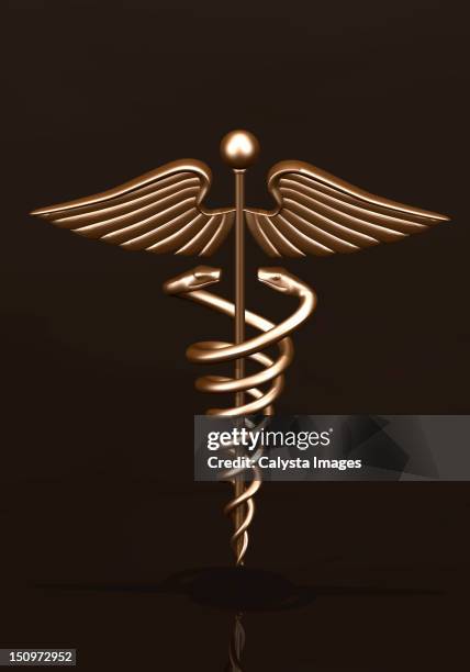 brass caduceus on dark background - caduceus stock pictures, royalty-free photos & images