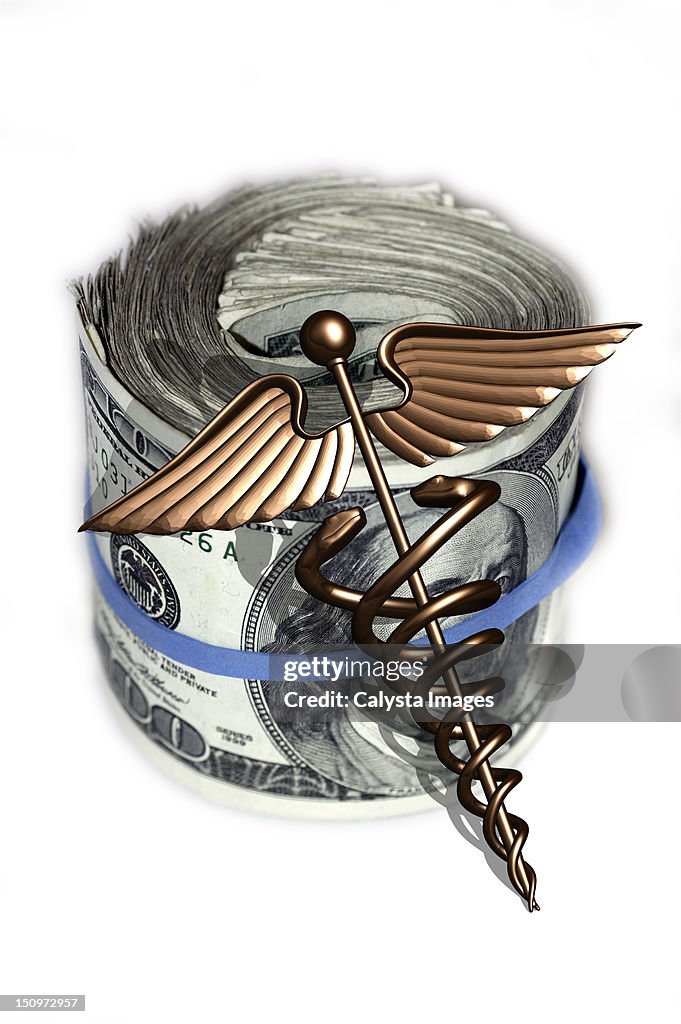 Caduceus and wad of us dollar bills