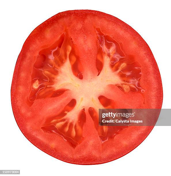 half of tomato on white background - segments fotografías e imágenes de stock