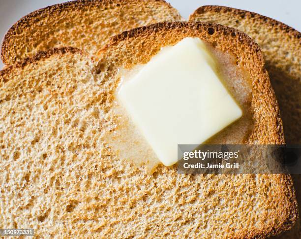 toast with meltin butter - bread and butter stock pictures, royalty-free photos & images