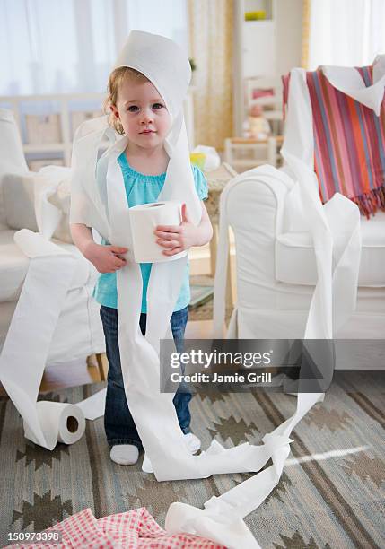 usa, new jersey, jersey city, girl (2-3) wrapped with toilet paper standing in living room - wrapped in toilet paper ストックフォトと画像