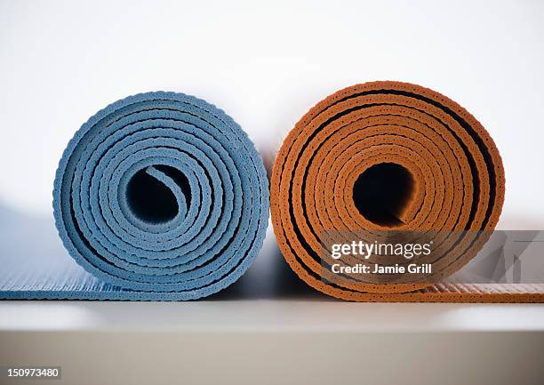 rolled-up yoga mats - mat stock pictures, royalty-free photos & images