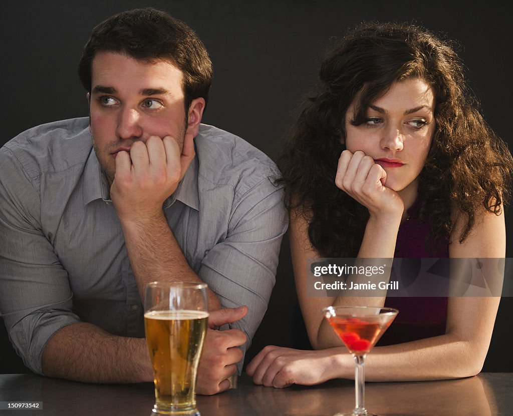 USA, New Jersey, Jersey City, Bored couple sitting at bar counter