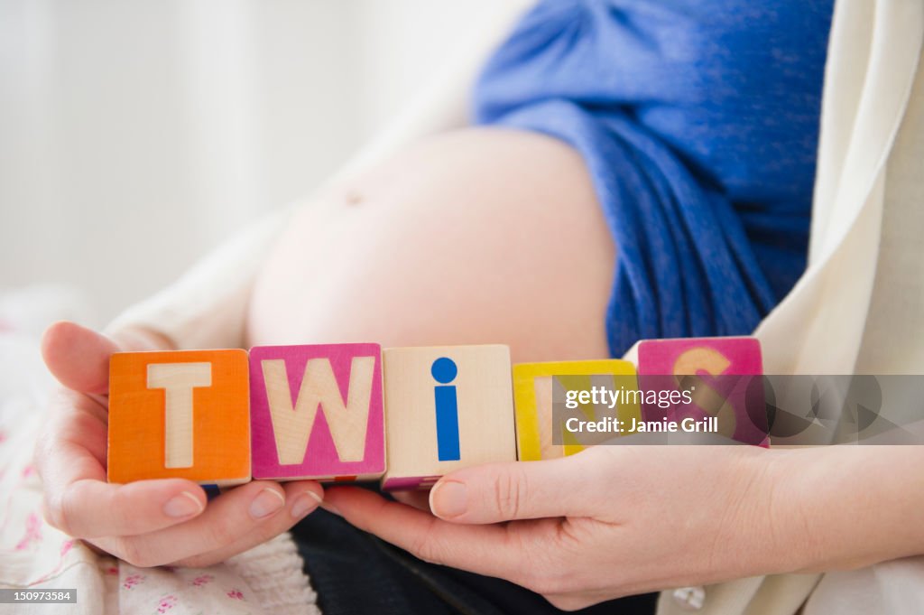 USA, New Jersey, Jersey City, Pregnant woman holding wooden blocks