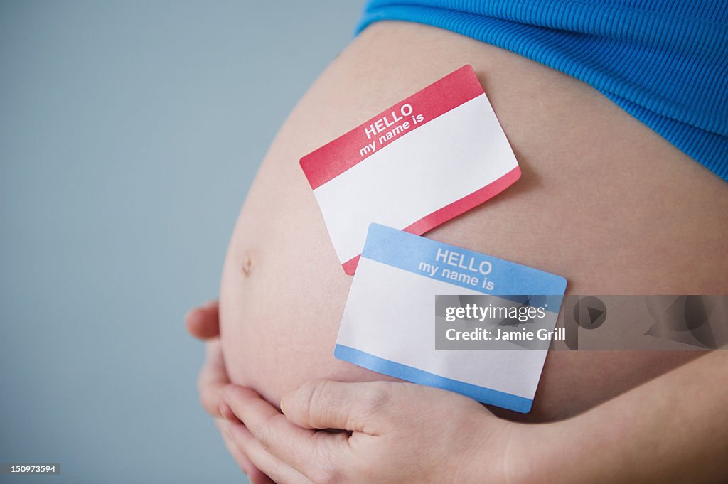 Name tags on belly of pregnant woman
