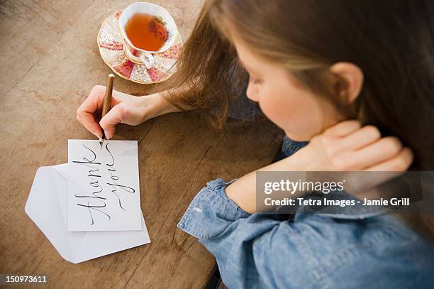 usa, new jersey, jersey city, woman writing greeting card - calligraphie photos et images de collection