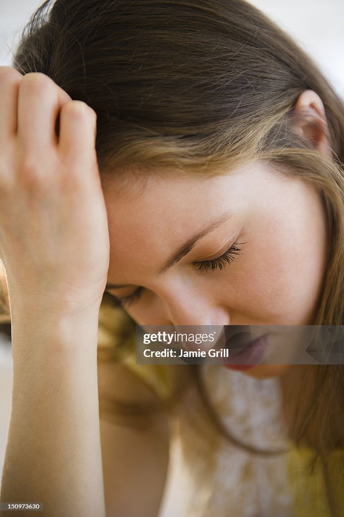 USA, New Jersey, Jersey City, Woman with head in hands