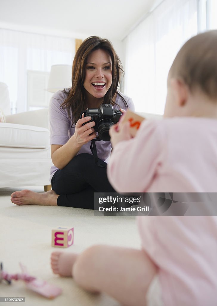 USA, New Jersey, Jersey City, Mother photographing baby daughter (6-11 months)