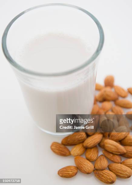 close up of almond milk and almonds - almond milk stock pictures, royalty-free photos & images