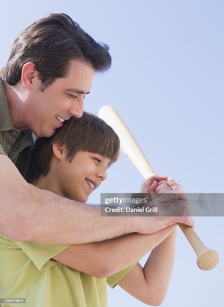 USA, New Jersey, Jersey City, Father teaching son (10-11 years) how to play baseball