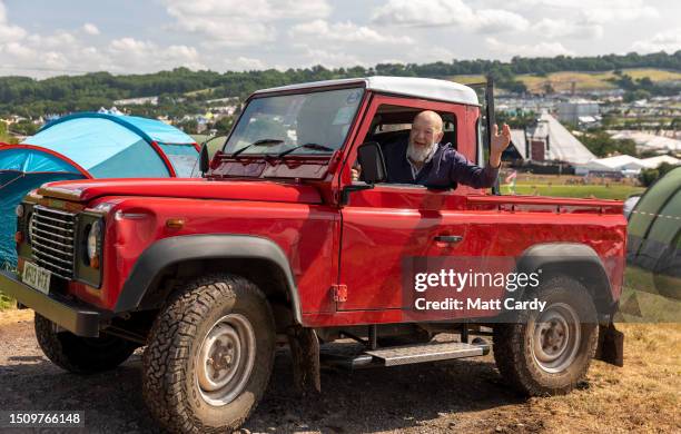 Festival founder Michael Eavis waves from his red Land Rover Defender as he tours the site at Worthy Farm, Pilton on Day 1 of Glastonbury Festival...