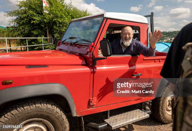 Festival founder Michael Eavis waves from his red Land Rover Defender as he tours the site at Worthy Farm, Pilton on Day 1 of Glastonbury Festival...