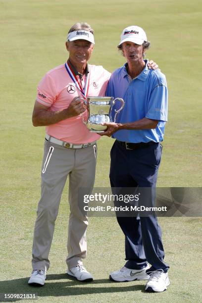 Bernhard Langer of Germany and caddie Terry Holt poses with the Francis D. Ouimet Memorial Trophy after winning the U.S. Senior Open Championship at...