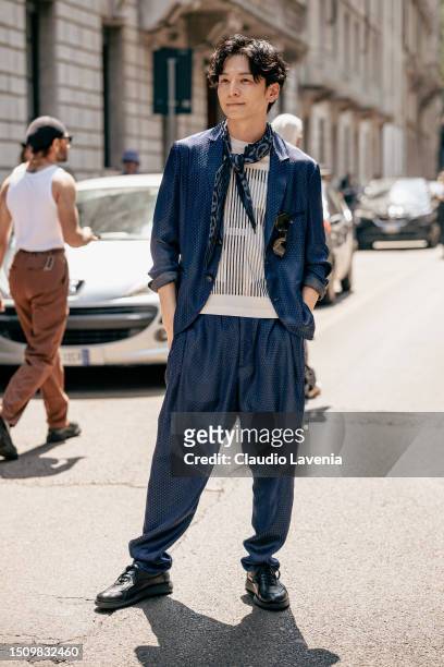 Tōma Ikuta, wearing blue suit and white stripped t-shirt, is seen outside Giorgio Armani show during the Milan Fashion Week - Menswear Spring/Summer...