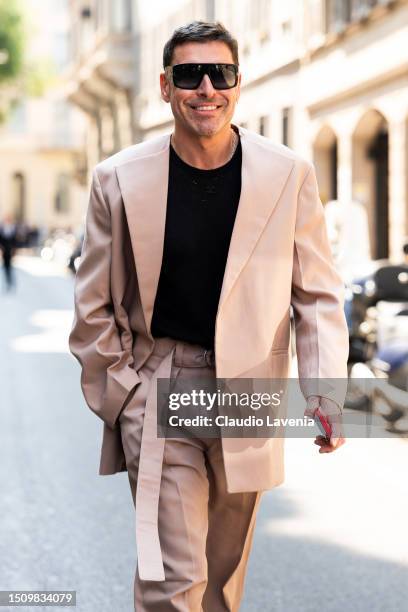 Alex Badia, wearing a beige suit, black t-shirt and sunglasses, is seen outside Giorgio Armani show during the Milan Fashion Week - Menswear...