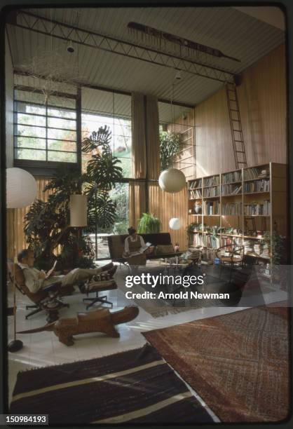 Married American designers Charles and Ray Eames read in the living room of their home and studio, Venice, California, November 16, 1974. This photo...