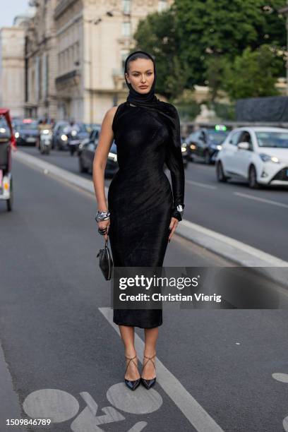 Guest wears black velvet dress, head scarf, heels, bag outside Alaia on July 02, 2023 in Paris, France.