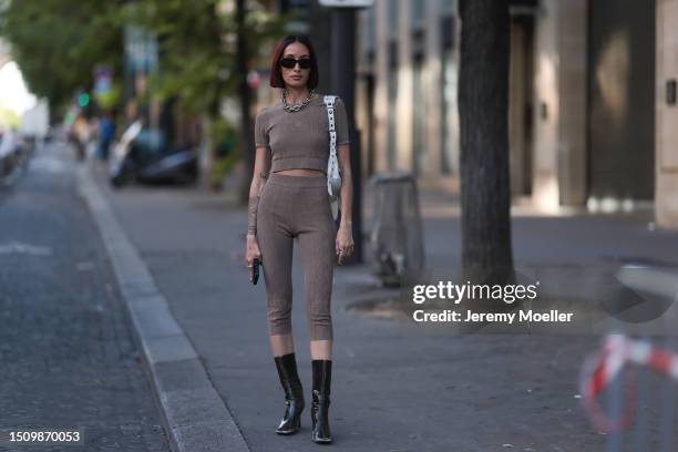 Alexandra Guerain is seen wearing black sunnies, heavy silver chain necklace, brown cotton set in brown, Balenciaga Le Cagole shoulder bag in white...