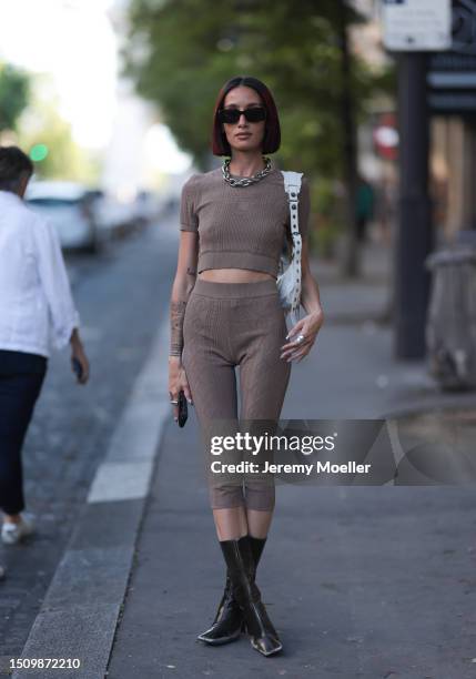 Alexandra Guerain is seen wearing black sunnies, heavy silver chain necklace, brown cotton set in brown, Balenciaga Le Cagole shoulder bag in white...