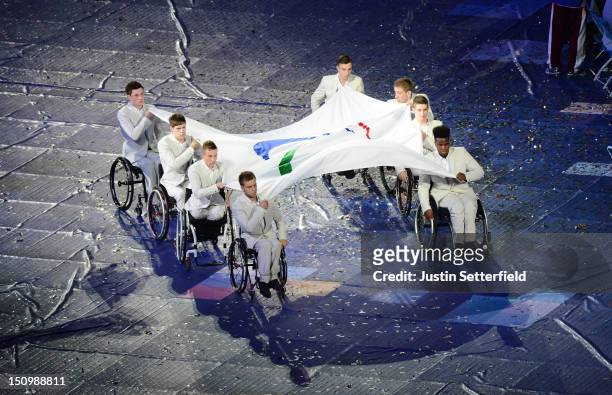 Eight members of the Great Britain U22 Wheelchair Basketball team carry the Paralympic flag during the Opening Ceremony of the London 2012...
