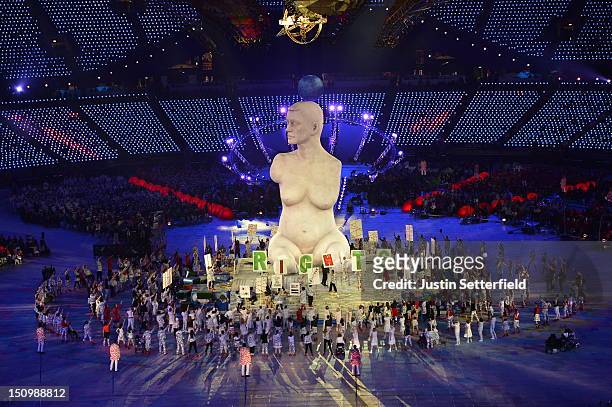Large-scale replica of Marc Quinn's sculpture, 'Alison Lapper Pregnant', emerges from the book stage during the Opening Ceremony of the London 2012...