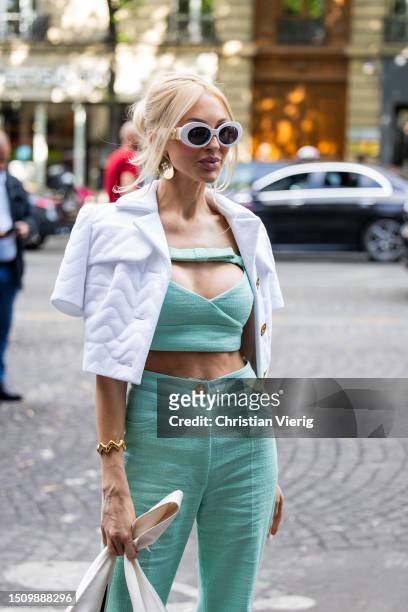 Christine Quinn wears green cropped top, pants, white jacket, bag, sunglasses outside Patou on July 02, 2023 in Paris, France.