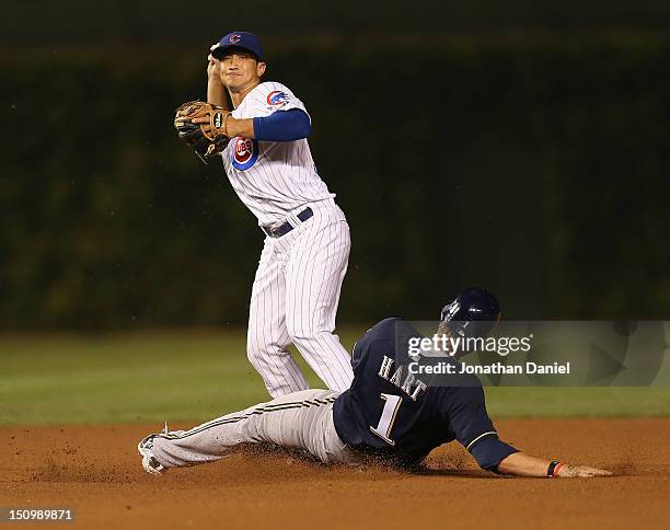 Darwin Barney of the Chicago Cubs tries to turn a double play as Corey Hart of the Milwaukee Brewers slides in at Wrigley Field on August 29, 2012 in...