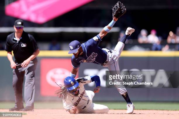 Vidal Brujan of the Tampa Bay Rays falls over J.P. Crawford of the Seattle Mariners at second base for the out during the sixth inning at T-Mobile...
