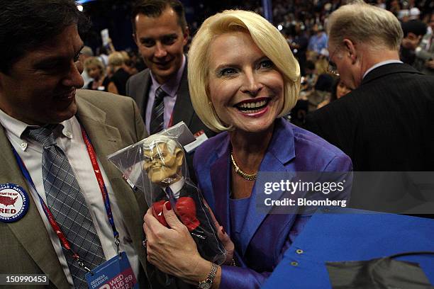 Callista Gingrich holds a doll of husband Newt Gingrich, former U.S. Speaker of the House, at the Republican National Convention in Tampa, Florida,...