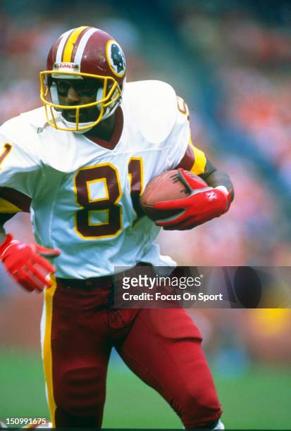 Wide Receiver Art Monk of the Washington Redskins runs with the ball after a catch during an NFL game circa 1990. Monk played for the Redskins from...