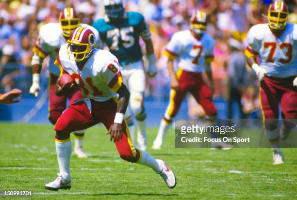Wide Receiver Art Monk of the Washington Redskins runs with the ball after a catch against the Miami Dolphins during an NFL football game at RFK...