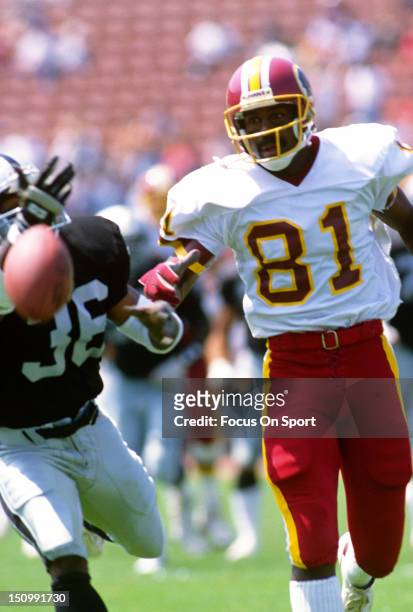 Wide Receiver Art Monk of the Washington Redskins has the ball knocked away from him by Terry McDaniel of the Los Angeles Raiders during an NFL game...