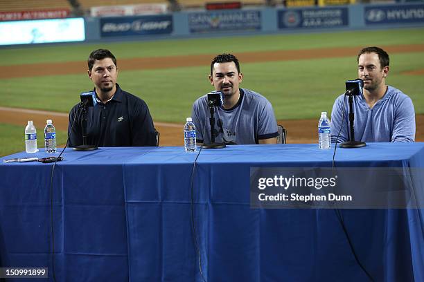 Newly arrived Los Angeles Dodgers Josh Becket , Adrian Gonzalez , and Nick Punto speak at a press conference after the game with the Miami Marlins on...