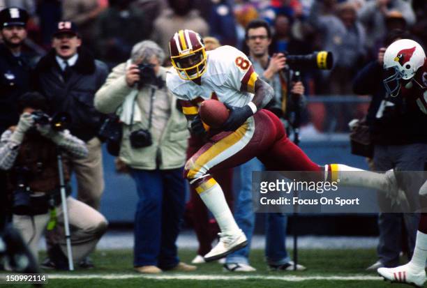 Wide Receiver Art Monk of the Washington Redskins catches a pass against the St. Louis Cardinals during an NFL football game at RFK Stadium December...