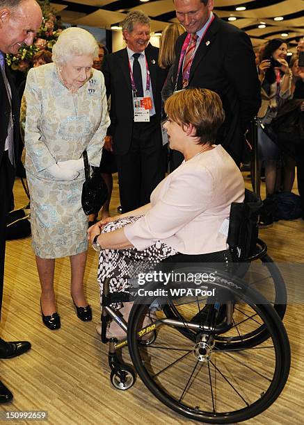 Queen Elizabeth II talks with Baroness Tanni Grey-Thompson at a reception at the Olympic Stadium ahead of the opening ceremony for the London...