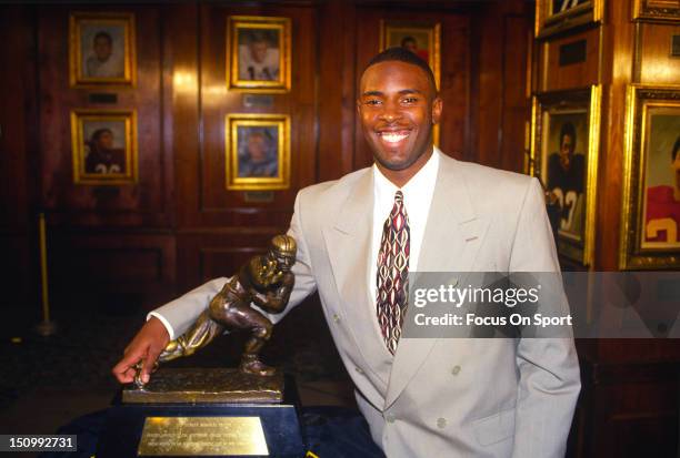 Charlie Ward of Florida State University poses with the Heisman Trophy at the Downtown Athletic Club circa 1993 in New York City, New York. Ward won...