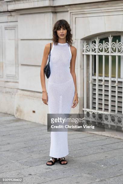 Mica Arganaraz wears white net dress outside Alaia on July 02, 2023 in Paris, France.