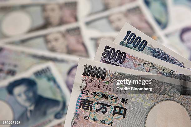 Japanese yen banknotes of various denominations are arranged for a photograph in Soka City, Saitama Prefecture, Japan, on Wednesday, Aug. 29, 2012....