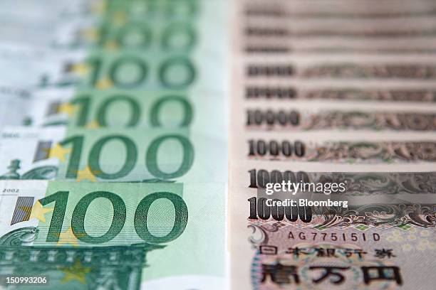 One-hundred euro banknotes, left, and ten-thousand yen banknotes are arranged for a photograph in Soka City, Saitama Prefecture, Japan, on Wednesday,...