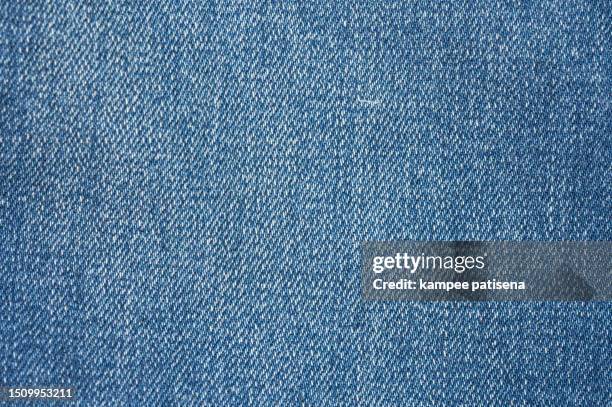 vintage blue denim texture background, close-up shot with subtle fading, perfect for fashion designers and bloggers - tejido vaquero fotografías e imágenes de stock