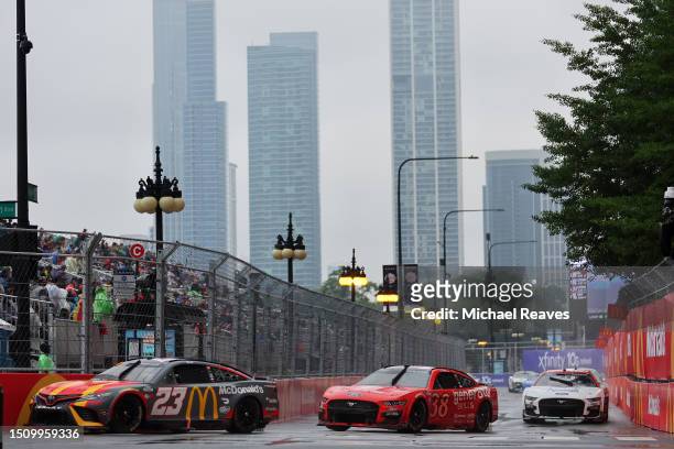 Bubba Wallace, driver of the McDonald's Toyota, and Todd Gilliland, driver of the gener8tor Skills Ford, race during the NASCAR Cup Series Grant Park...