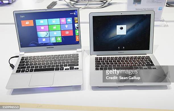 An ultra thin Samsung Notebook Series 9 laptop computer runnung Microsoft Windows 8 sits next to an Apple Macbook Air brought by a visitor during a...