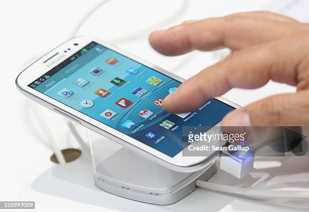 Visitor tries out a Samsung Galaxy S III smartphone during a press day at the Samsung stand at the IFA 2012 consumer electronics trade fair on August...