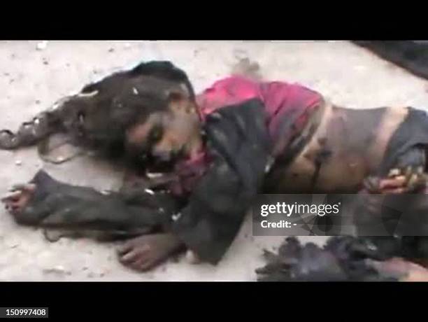 An image grab taken from a video uploaded on YouTube on July 30, 2012 shows the body of a Syrian girl allegedly killed when a shell fell on civilians...