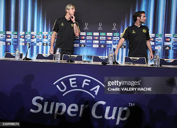 Chelsea's Spanish forward Fernando Torres and Chelsea's Spanish midfielder Juan Mata arrive to give a press conference on the eve of the UEFA Super...