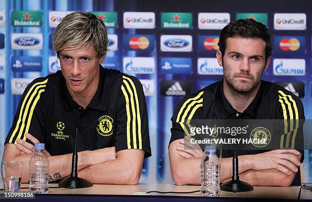 Chelsea's Spanish forward Fernando Torres speaks neaer Chelsea's Spanish midfielder Juan Mata during a press conference on the eve of the UEFA Super...