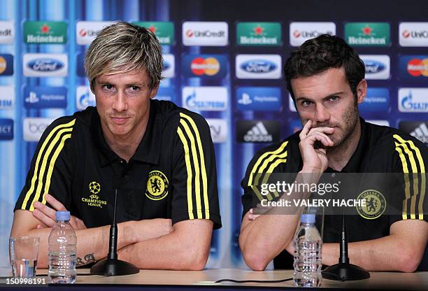 Chelsea's Spanish forward Fernando Torres speaks neaer Chelsea's Spanish midfielder Juan Mata during a press conference on the eve of the UEFA Super...